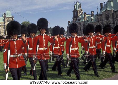 Stock Image -  Ottawa, guards, Parliament, Ontario, Canada, Changing of the Guards takes place on the lawn of the Parliament Buildings on Parliament Hill in Ottawa the capital city of Canada in the Province of Ontario. Guards are wearing red jackets, black fuzzy hats, . Fotosearch