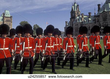 Stock Photo -  Ottawa, guards, Parliament, Ontario, Canada, Changing of the Guards takes place on the lawn of the Parliament Buildings on Parliament Hill in Ottawa the capital city of Canada in the Province of Ontario. Guards are wearing red jackets, black fuzzy hats, . Fotosearch