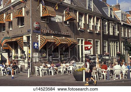 Picture -  outdoor cafe, Amsterdam, Holland, Netherlands, Europe, People sitting at an outdoor cafe in downtown Amsterdam.. Fotosearch