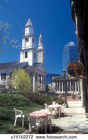 Stock Image -  outdoor cafe, Massachusetts, Springfield, Old First Church built in 1819 and downtown shops and cafe in Springfield, Massachusetts in the spring.. Fotosearch