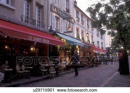 Stock Image -  outdoor cafe, Paris, France, Europe, Montmartre, People sitting at an outdoor cafe in the [evening, night] at the Place du Tertre in Montmartre.. Fotosearch
