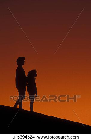 Picture -  overlook, Silhouette, people, Stone Mountain, Georgia's Stone Mountain Park, Atlanta, Georgia, Silhouette of mother and young daughter watching/looking at sunset on the summit of Stone Mountain in Georgia's Stone Mt. Park near Atlanta in the state of Geo. Fotosearch