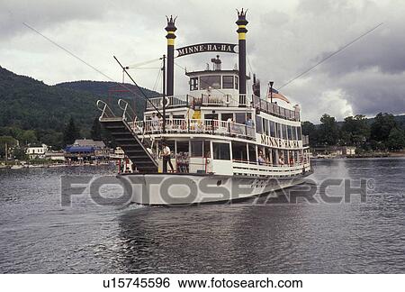 Stock Photograph -  paddlewheel, boat, Lake George, Adirondacks, Adirondack Park, Adirondack, New York, The Minne-ha-ha Paddlewheel tourboat cruises slowly along the waterfront of Lake George in the village of Lake George in the state of New York. . Fotosearch
