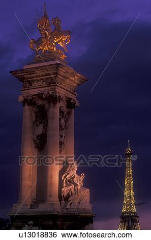 Stock Photograph -  Paris, Eiffel Tower, France, Europe, A monument at The Pont Alexandre in the [evening, night] with the Eiffel Tower in the background in Paris.. Fotosearch