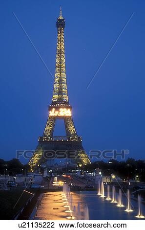 Stock Image -  Paris, Eiffel Tower, France, Europe, Evening, City of Light, A view of the magnificent Eiffel Tower illuminated at night from the fountain at Jardins du Trocadero in Paris, France.. Fotosearch