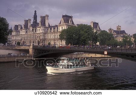 Paris, France, boat, Europe, Seine River, A scenic view of the Rive Droite (Right Bank) and Hotel de Ville (City Hall) as a bateau mouche (tourboat) makes it way down the Seine River in Paris. View Large Photo Image Stock Image - Paris, France, boat, Europe, Seine River, A scenic view of the Rive Droite (Right Bank) and Hotel de Ville (City Hall) as a bateau mouche (tourboat) makes it way down the Seine River in Paris.. Fotosearch