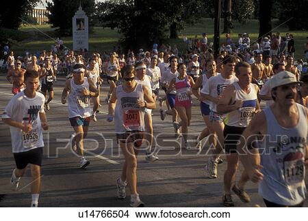 Picture -  Peachtree Road Race, Atlanta, running, 10K, Long Distance, Georgia, A group of people running in the 10K Peachtree Road Race in Atlanta in the state of Georgia.. Fotosearch