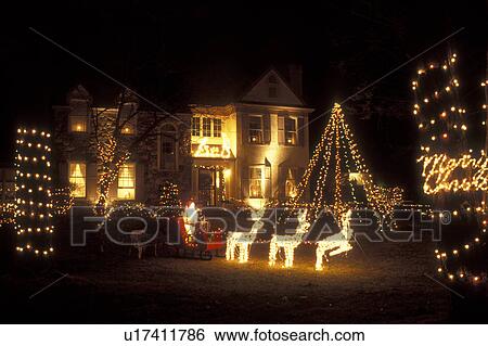 Pennsylvania, Christmas lights and figurines decorate the front yard of a large house in the evening in Berwyn. View Large Photo Image Stock Photograph - Pennsylvania, Christmas lights and figurines decorate the front yard of a large house in the evening in Berwyn.. Fotosearch