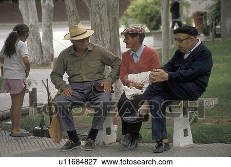 people, Patagonia, Argentina, Three local men sitting on a bench in a park talking in Trelew. View Large Photo Image Stock Photo - people, Patagonia, Argentina, Three local men sitting on a bench in a park talking in Trelew. . Fotosearch