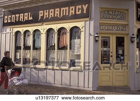 Pharmacy, Cape May, New Jersey, A woman walks a baby in a stroller by the Central Pharmacy store in Cape May in the state of New Jersey. View Large Photo Image Stock Photo - Pharmacy, Cape May, New Jersey, A woman walks a baby in a stroller by the Central Pharmacy store in Cape May in the state of New Jersey. . Fotosearch