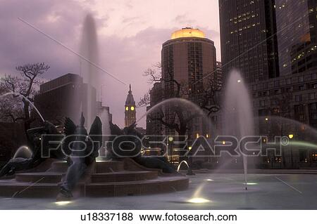 Stock Photo -  Philadelphia, fountain, Pennsylvania, Fountain at Logan Circle with the Philadelphia downtown skyline in the evening, Pennsylvania. The fountain was cast by Alexander Stirling Calder.. Fotosearch