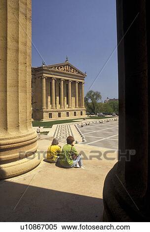 Stock Photography -  Philadelphia, museum, Pennsylvania, Two people sitting on the steps of the Philadelphia Museum of Art in downtown Philadelphia in the state of Pennsylvania. . Fotosearch