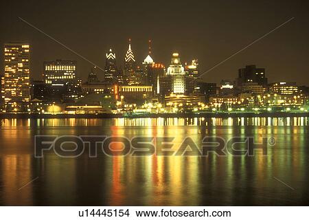 Philadelphia, skyline, Pennsylvania, The illuminated skyline of downtown Philadelphia reflects in the calm waters of the Delaware River in the evening, Pennsylvania. View Large Photo Image Picture - Philadelphia, skyline, Pennsylvania, The illuminated skyline of downtown Philadelphia reflects in the calm waters of the Delaware River in the evening, Pennsylvania.. Fotosearch