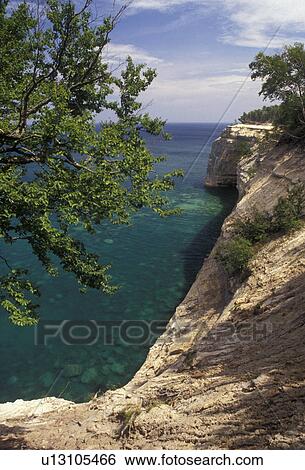Stock Photograph -  Pictured Rocks, Lake Superior, sandstone cliffs, Upper Peninsula, U. P Michigan, Scenic view of sandstone cliffs along the coast of Lake Superior at Pictured Rocks National Lakeshore in Munising in the state of Michigan.. Fotosearch