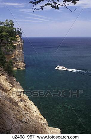 Stock Photo -  Pictured Rocks, Lake Superior, Upper Peninsula, U. P Michigan, Scenic view of a tourboat on Lake Superior at Pictured Rocks National Lakeshore in Munising in the state of Michigan.. Fotosearch