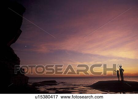 Pictured Rocks, silhouette, sunset, sunrise, Lake Superior, Upper Peninsula, U. P Michigan, Mother and daughter standing on the edge of Lake Superior at sunset at Pictured Rocks National Lakeshore in Munising in the state of Michigan. View Large Photo Image Stock Photo - Pictured Rocks, silhouette, sunset, sunrise, Lake Superior, Upper Peninsula, U. P Michigan, Mother and daughter standing on the edge of Lake Superior at sunset at Pictured Rocks National Lakeshore in Munising in the state of Michigan.. Fotosearch
