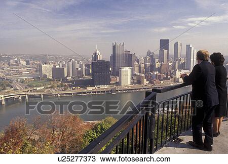 Pittsburgh, skyline, Pennsylvania, A couple looks at the downtown skyline of Pittsburgh across the Monongahela River from the overlook at Mount Washington in the state of Pennsylvania. View Large Photo Image Stock Image - Pittsburgh, skyline, Pennsylvania, A couple looks at the downtown skyline of Pittsburgh across the Monongahela River from the overlook at Mount Washington in the state of Pennsylvania. . Fotosearch