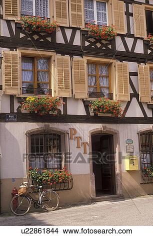 Picture -  post office, Alsace, France, Andlau, wine region, Europe, Bas-Rhin, Flowers in window boxes decorate the facade of the half timbered post office building in Andlau.. Fotosearch