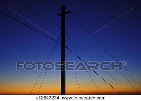 Picture -  power lines, sunset, Silhouette of power lines at sunset on the summit of Stone Mountain at Georgia's Stone Mountain Park . Fotosearch