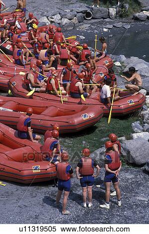 rafting, white water, Alps, France, Europe, Rafters getting instructions before heading to the white waters of the Isere River in Savoie. Rafters wearing red helmets and red life vests. View Large Photo Image Stock Photography - rafting, white water, Alps, France, Europe, Rafters getting instructions before heading to the white waters of the Isere River in Savoie. Rafters wearing red helmets and red life vests.. Fotosearch