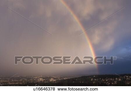 Stock Photo -  rainbow, Burgundy, France, Dijon, Europe, A colorful rainbow over Dijon the capital city of Burgundy, France after a rain storm. . Fotosearch