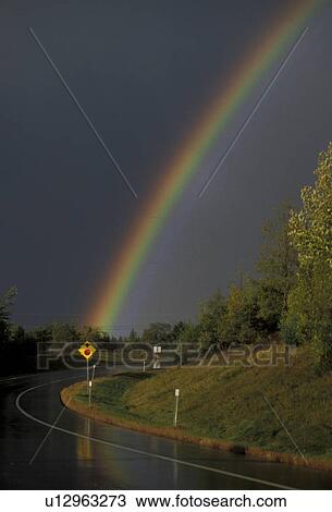 rainbow, road, Maine, A colorful rainbow appears over a rain sleek road after a thunderstorm. View Large Photo Image Stock Image - rainbow, road, Maine, A colorful rainbow appears over a rain sleek road after a thunderstorm.. Fotosearch