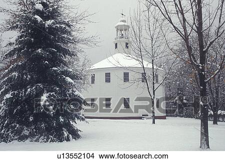 Picture -  Richmond, round church, winter, Vermont, The Old Round Church (a 16 sided polygon) National Historical Landmark in the winter in the town of Richmond in Chittenden County in the state of Vermont.. Fotosearch