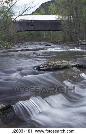 Stock Image -  river, covered bridge, Vermont, VT, The Flint Covered Bridge, ca. 1845, crosses over the First Branch White River in Tunbridge in the spring. . Fotosearch