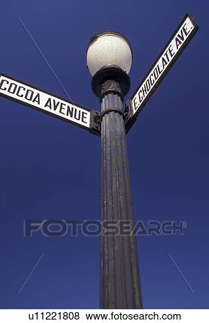 Stock Photo -  road signs, Hershey, chocolate, Pennsylvania, East Chocolate Avenue and Cocoa Avenue street signs on a black post against a blue sky in downtown Hershey in the state of Pennsylvania. . Fotosearch