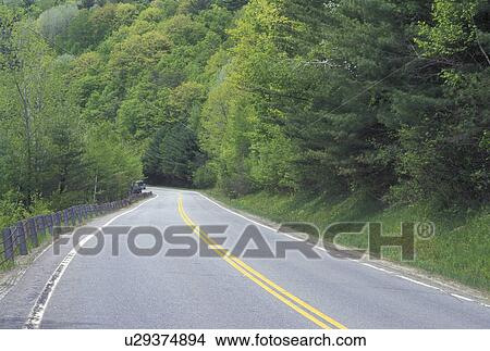 road, Vermont, VT, Route 131 in Downers winds through the light green forest of trees in the spring. View Large Photo Image Picture - road, Vermont, VT, Route 131 in Downers winds through the light green forest of trees in the spring.. Fotosearch