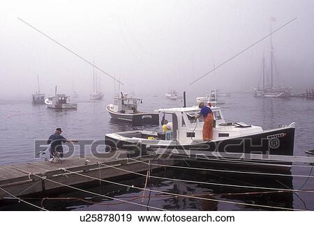 Rockport, Maine, Lobster, fog, Atlantic Ocean, Fisherman cleaning fishing boat while another man sits fishing from the dock in the fog. View Large Photo Image Stock Photo - Rockport, Maine, Lobster, fog, Atlantic Ocean, Fisherman cleaning fishing boat while another man sits fishing from the dock in the fog.. Fotosearch