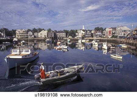 Rockport, Massachusetts, Atlantic Ocean, Boats (fishing, lobster) in the harbor of a scenic fishing village. A fisherman chugs along in his dinghy. The boats reflect in the calm water. View Large Photo Image Stock Photo - Rockport, Massachusetts, Atlantic Ocean, Boats (fishing, lobster) in the harbor of a scenic fishing village. A fisherman chugs along in his dinghy. The boats reflect in the calm water.. Fotosearch