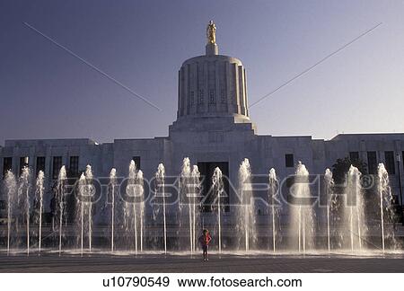 Salem, State Capitol, State House, Oregon, Young girl stands at the fountains in front of the State Capitol Building in the capital city of Salem in the state of Oregon. View Large Photo Image Stock Photo - Salem, State Capitol, State House, Oregon, Young girl stands at the fountains in front of the State Capitol Building in the capital city of Salem in the state of Oregon. . Fotosearch