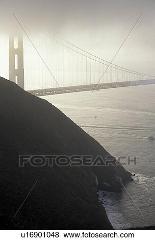 Stock Photo -  San Francisco, The Golden Gate Bridge, California, The Golden Gate Bridge of San Francisco in heavy fog over the San Francisco Bay, the longest single-span suspension bridges ever built, in the state of California. . Fotosearch