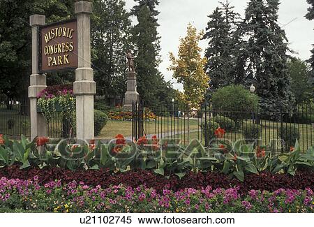 Stock Photography -  Saratoga Springs, New York, Flowers decorate the entrance to Historic Congress Park in the town of Saratoga Springs in the state of New York., . Fotosearch