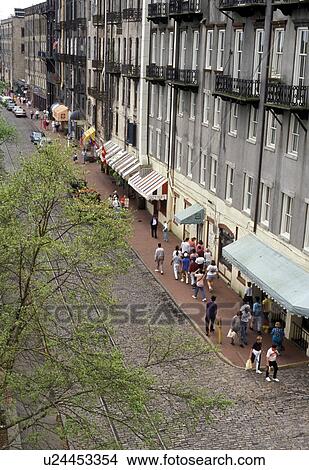 Savannah, Georgia, Waterfront, Aerial view of people walking along the cobblestone River Street in the Historic Riverfront District of Savannah in the state of Georgia. View Large Photo Image Picture - Savannah, Georgia, Waterfront, Aerial view of people walking along the cobblestone River Street in the Historic Riverfront District of Savannah in the state of Georgia. . Fotosearch