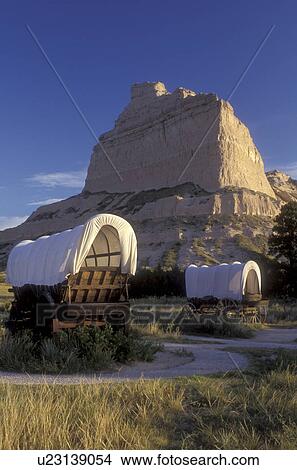 Scotts Bluff, Nebraska, Covered wagon exhibits with wind-sculpted bluff in background at Scotts Bluff National Monument., View Large Photo Image Picture - Scotts Bluff, Nebraska, Covered wagon exhibits with wind-sculpted bluff in background at Scotts Bluff National Monument., . Fotosearch