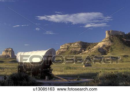 Scotts Bluff, Nebraska, Covered wagon exhibit sits on the prairie in Scotts Bluff National Monument. Wind-sculpted bluffs in background View Large Photo Image Stock Image - Scotts Bluff, Nebraska, Covered wagon exhibit sits on the prairie in Scotts Bluff National Monument. Wind-sculpted bluffs in background . Fotosearch