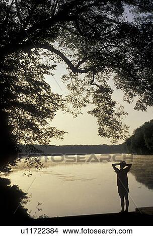 silhouette, Potomac River, Chesapeake and Ohio Canal Trail, Maryland, Silhouette of woman standing along the Potomac River at the Chesapeake and Ohio Canal National Historic Park in the state of Maryland. View Large Photo Image Picture - silhouette, Potomac River, Chesapeake and Ohio Canal Trail, Maryland, Silhouette of woman standing along the Potomac River at the Chesapeake and Ohio Canal National Historic Park in the state of Maryland. . Fotosearch