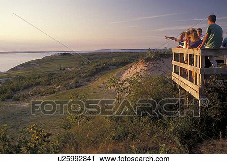 Sleeping Bear Dunes, Michigan, People at an observation deck looking at the impressive coastline of Lake Michigan at Sleeping Bear Dunes National Lakeshore in the state of Michigan View Large Photo Image Stock Image - Sleeping Bear Dunes, Michigan, People at an observation deck looking at the impressive coastline of Lake Michigan at Sleeping Bear Dunes National Lakeshore in the state of Michigan . Fotosearch
