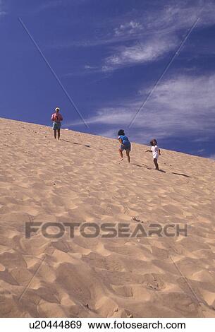 Sleeping Bear Dunes, sand dune, dune climb, Michigan, Children climbing up the steep towering sand dune (a perched dune) at Sleeping Bear Dunes National Lakeshore in the state of Michigan. View Large Photo Image Stock Photo - Sleeping Bear Dunes, sand dune, dune climb, Michigan, Children climbing up the steep towering sand dune (a perched dune) at Sleeping Bear Dunes National Lakeshore in the state of Michigan.. Fotosearch