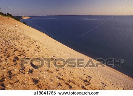 Sleeping Bear Dunes, sand dune, Lake Michigan, Michigan, The impressive coastline along Lake Michigan with steep sand dunes (a perched dune) at Sleeping Bear Dunes National Lakeshore in the state of Michigan. View Large Photo Image Stock Photography - Sleeping Bear Dunes, sand dune, Lake Michigan, Michigan, The impressive coastline along Lake Michigan with steep sand dunes (a perched dune) at Sleeping Bear Dunes National Lakeshore in the state of Michigan.. Fotosearch