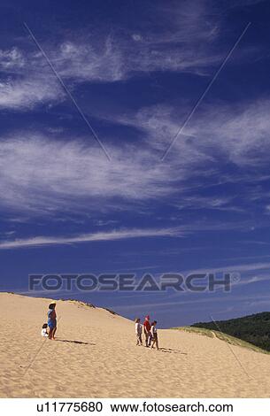 Sleeping Bear Dunes, sand dune, Michigan, People walking down the steep towering sand dune (a perched dune) at Sleeping Bear Dunes National Lakeshore in the state of Michigan. View Large Photo Image Stock Image - Sleeping Bear Dunes, sand dune, Michigan, People walking down the steep towering sand dune (a perched dune) at Sleeping Bear Dunes National Lakeshore in the state of Michigan.. Fotosearch