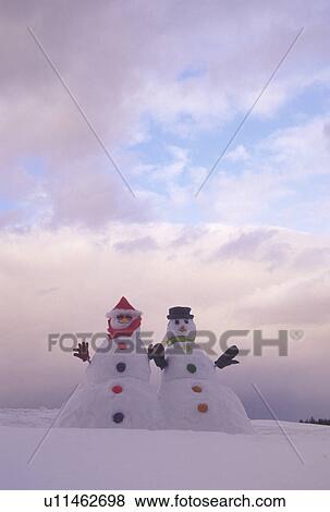 Stock Photo -  snowman, Vermont, VT, Snowman couple on a snow-covered hill in winter. Fotosearch