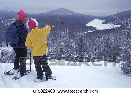 snowshoeing, Vermont, VT, Mother and daughter snowshoeing on Owl's Head overlooking the frozen Kettle Pond in Groton State Forest in winter. View Large Photo Image Stock Image - snowshoeing, Vermont, VT, Mother and daughter snowshoeing on Owl's Head overlooking the frozen Kettle Pond in Groton State Forest in winter.. Fotosearch
