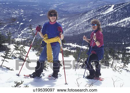 snowshoeing, Vermont, VT, Mother and daughter snowshoeing on Mt. Mansfield overlooking the village of Stowe in winter. View Large Photo Image Stock Photo - snowshoeing, Vermont, VT, Mother and daughter snowshoeing on Mt. Mansfield overlooking the village of Stowe in winter.. Fotosearch