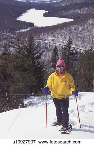 snowshoeing, Vermont, VT, Woman snowshoeing on Owl's Head overlooking the frozen Kettle Pond in Groton State Forest in winter. View Large Photo Image Stock Photo - snowshoeing, Vermont, VT, Woman snowshoeing on Owl's Head overlooking the frozen Kettle Pond in Groton State Forest in winter.. Fotosearch