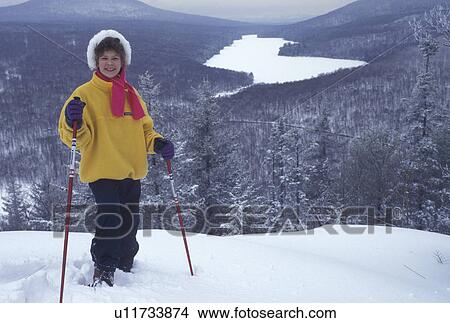 snowshoeing, Vermont, VT, Young girl snowshoeing on Owl's Head overlooking the frozen Kettle Pond in Groton State Forest in winter. View Large Photo Image Picture -  snowshoeing, Vermont, VT, Young girl snowshoeing on Owl's Head overlooking the frozen Kettle Pond in Groton State Forest in winter.. Fotosearch
