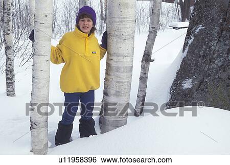 Stock Photograph -  snowshoeing, Vermont, VT, Young girl snowshoeing, birch trees, Groton State Forest, winter.. Fotosearch