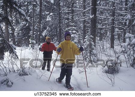 snowshoeing, winter, Vermont, Mother and daughter (10 years old) snowshoe together in the snow covered woods on a winter day in Groton State Forest in Caledonia County in the state of Vermont. View Large Photo Image Stock Photography - snowshoeing, winter, Vermont, Mother and daughter (10 years old) snowshoe together in the snow covered woods on a winter day in Groton State Forest in Caledonia County in the state of Vermont.. Fotosearch
